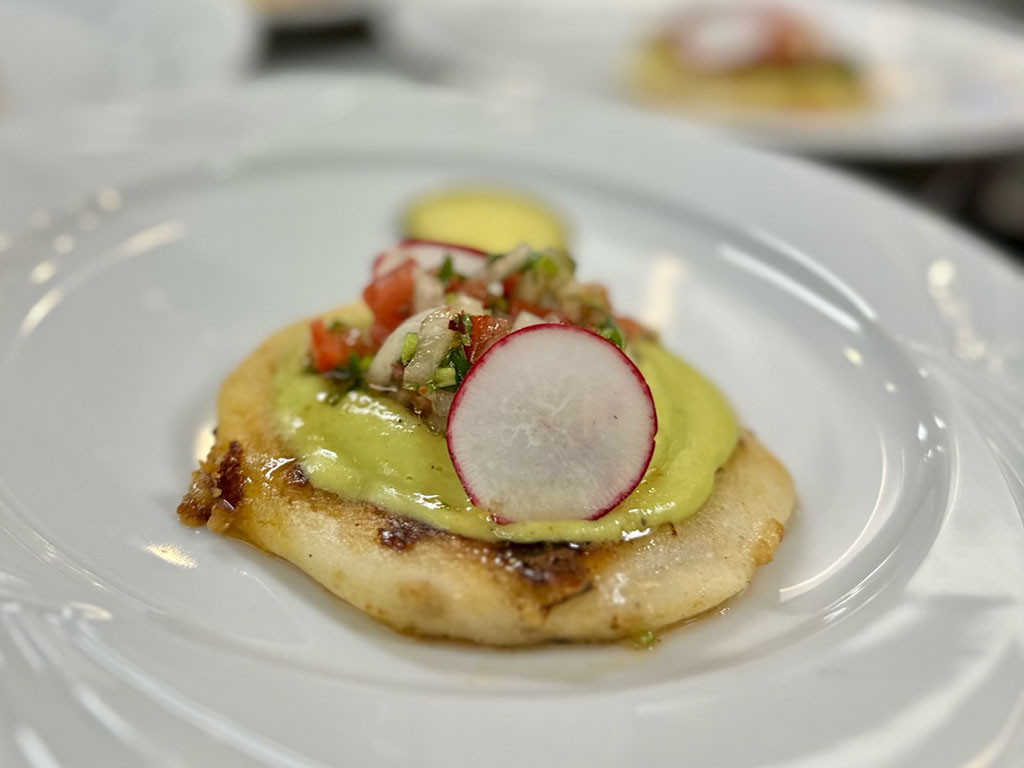 Turkey stuffed pupusa, avocado crema and pebre sauce image